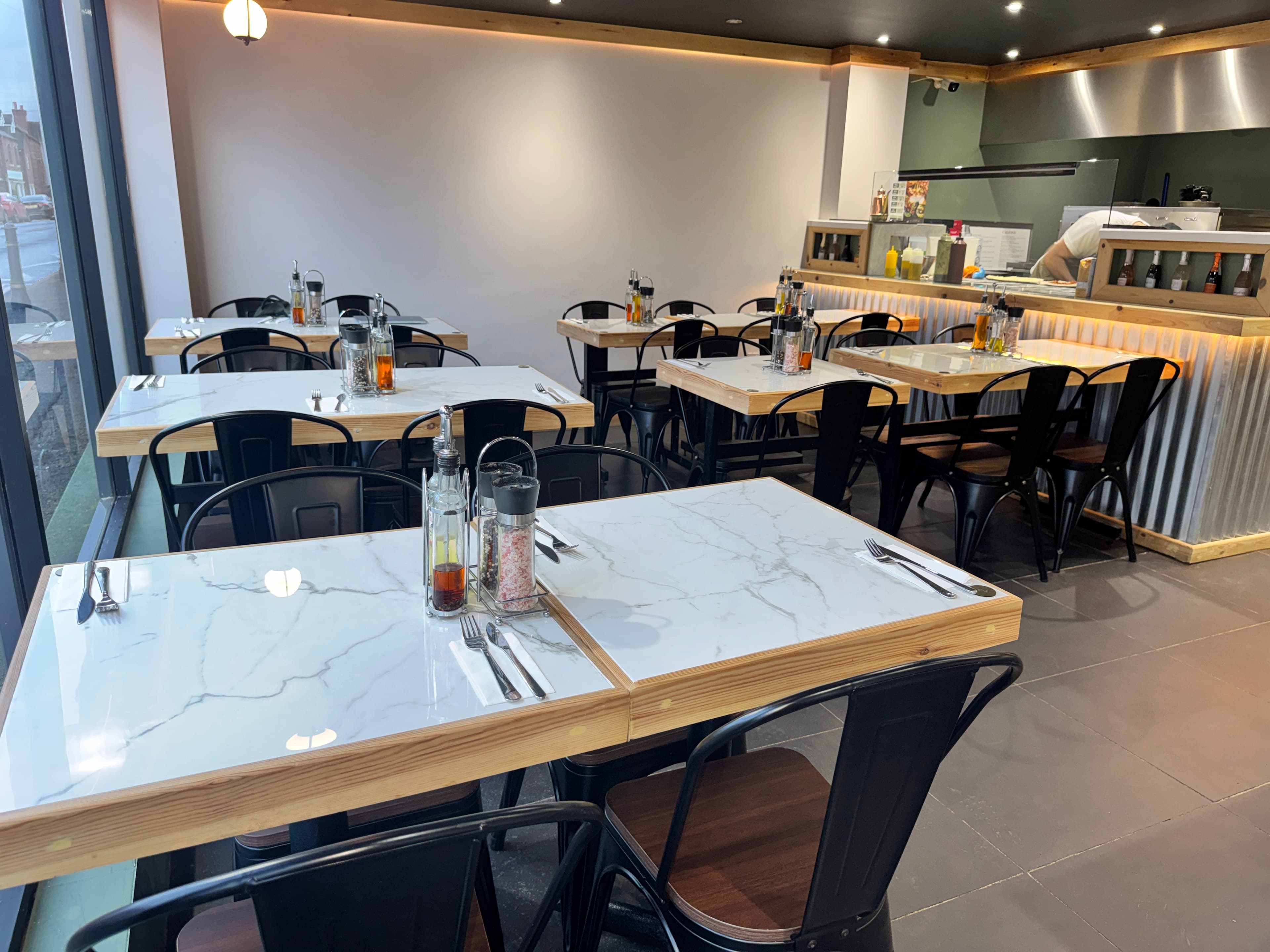 Marble-topped tables in the dining room at 500° Alsager.